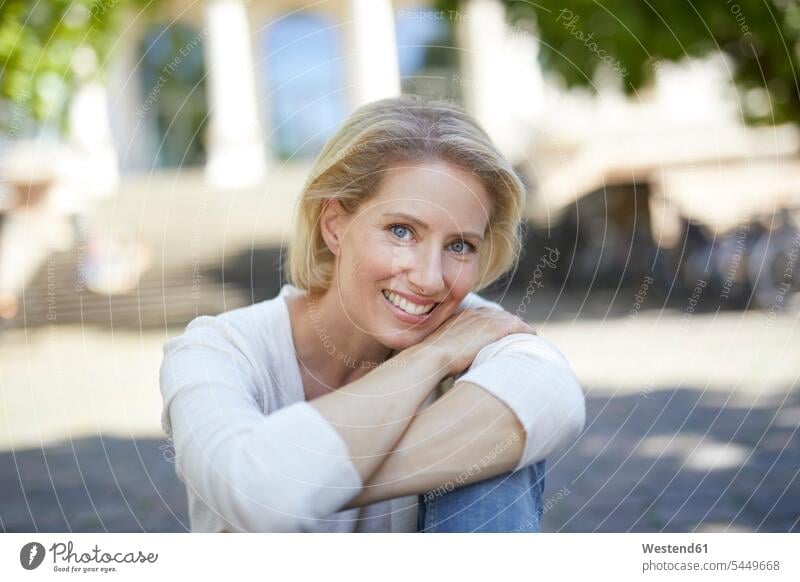 Portrait of smiling blond woman with arms crossed females women portrait portraits Adults grown-ups grownups adult people persons human being humans