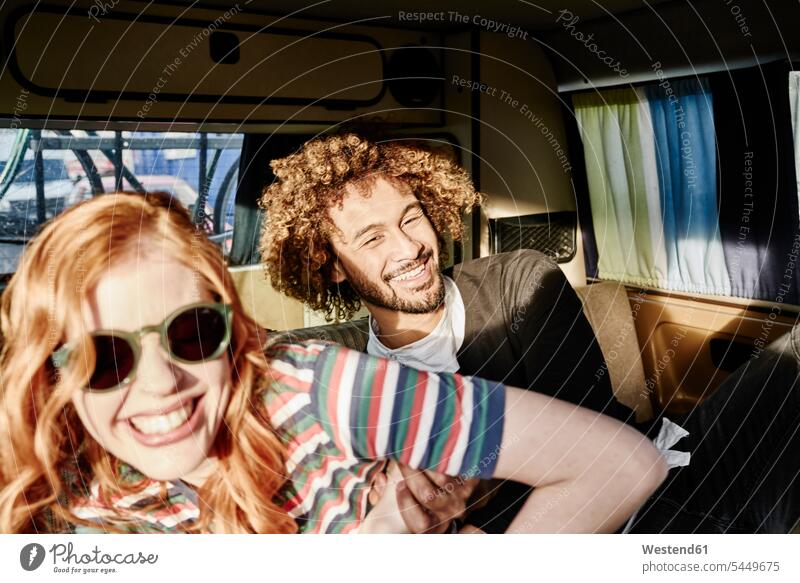 Happy young couple in a van car automobile Auto cars motorcars Automobiles twosomes partnership couples happiness happy smiling smile motor vehicle road vehicle