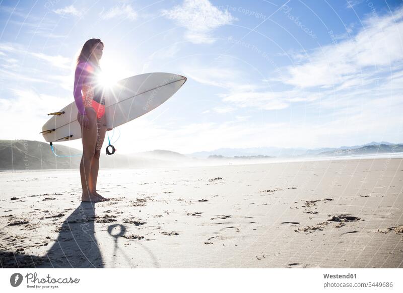 Woman carrying surfboard on the beach surfboards surfer female surfer surfers female surfers beaches woman females women surfing surf ride surf riding