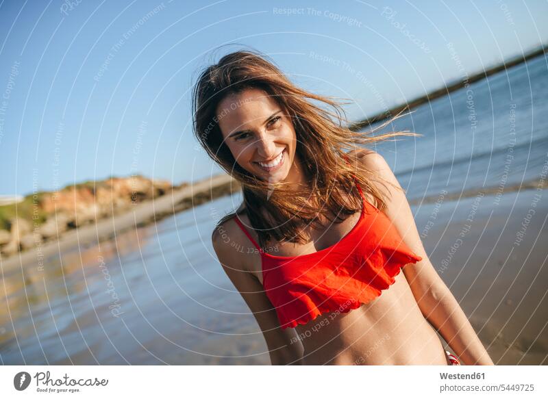 Portrait of happy young woman on the beach portrait portraits beaches females women Adults grown-ups grownups adult people persons human being humans