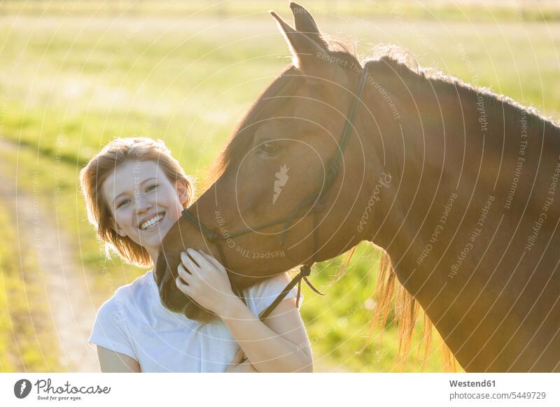 Portrait of happy of young woman with horse at backlight females women equus caballus horses Adults grown-ups grownups adult people persons human being humans