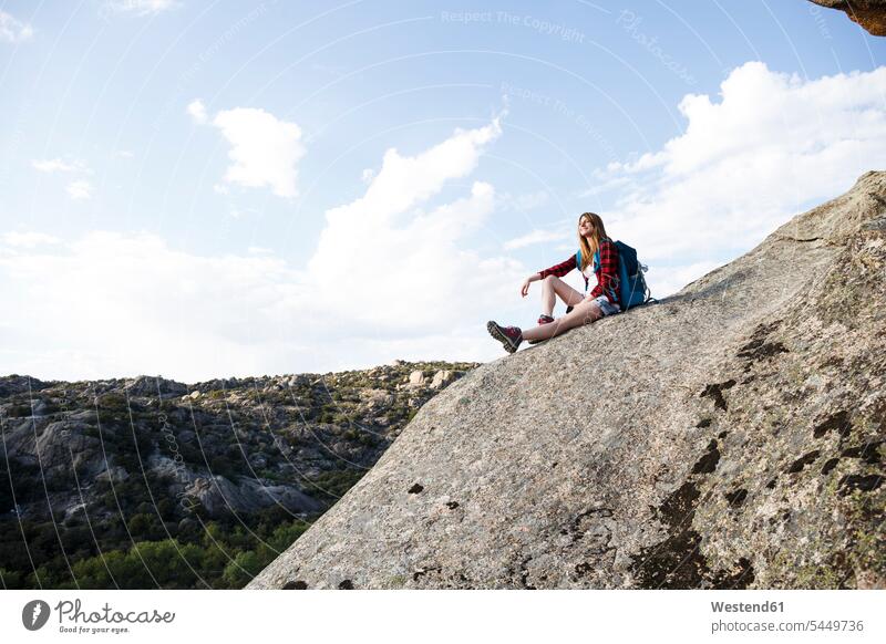 Spain, Madrid, young woman resting on a rock during a trekking day sitting Seated rocks hiking hike mountain mountains females women landscape landscapes