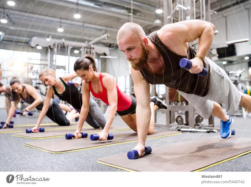 Group of athletes exercising with dumbbells in gym gyms Health Club pushup Push-up Push-ups pushups press-up press-ups Push Up Push Ups exercise training