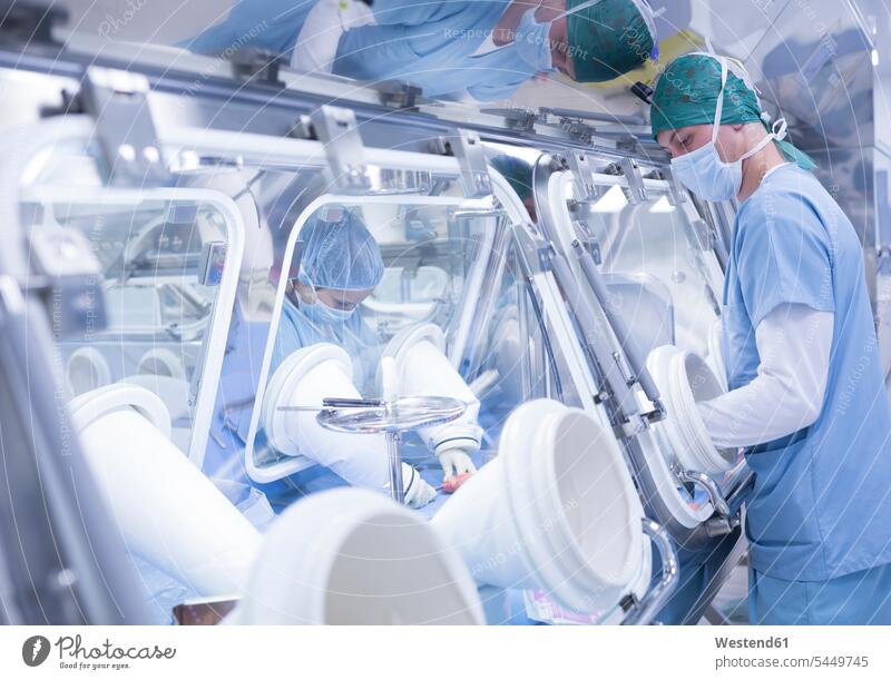 Scientists processing human tissue in insulator laboratory science sciences scientific scientist workplace work place place of work Cooperation working together