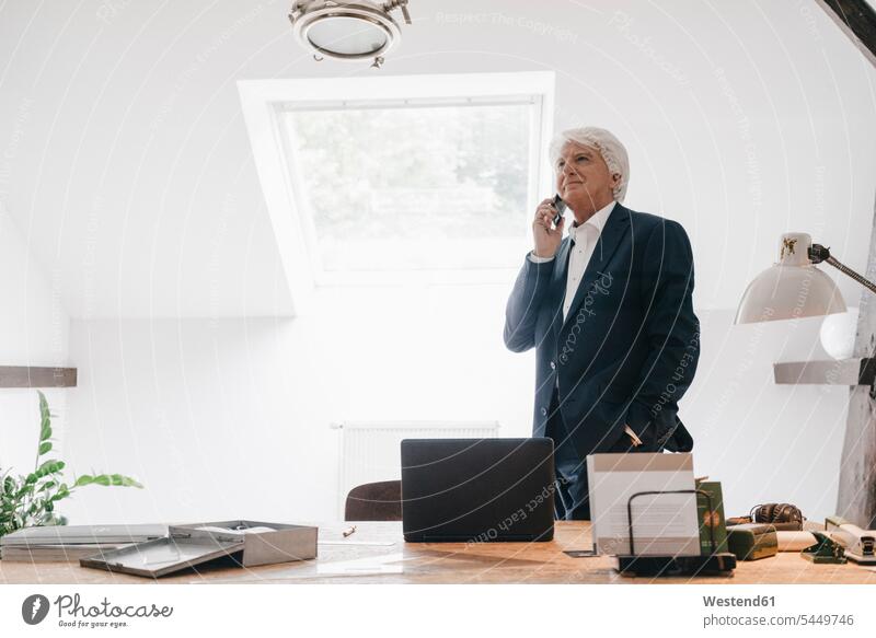 Senior businessman on the phone in his office call telephoning On The Telephone calling Businessman Business man Businessmen Business men telephone call