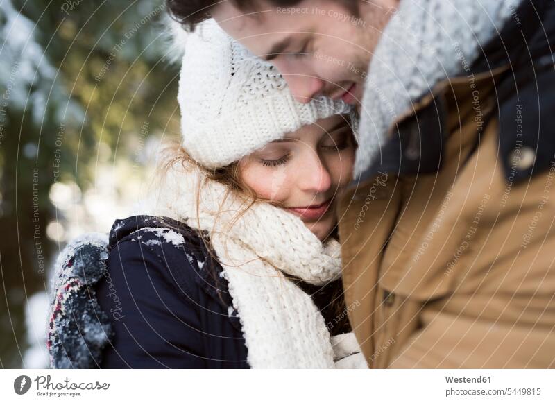 Happy young couple in winter woman females women portrait portraits happiness happy Adults grown-ups grownups adult people persons human being humans