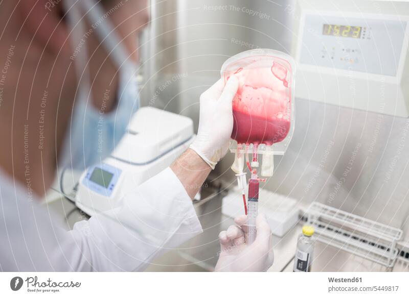 Scientist working with blood bag in lab At Work laboratory technician Lab Tech human blood scientist examining checking examine science sciences scientific