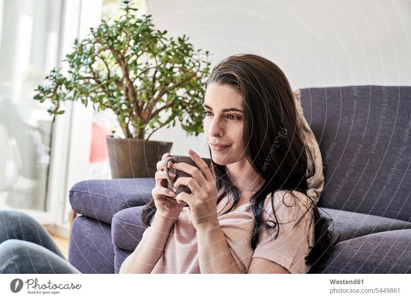 Young woman with coffee mug at home Coffee relaxed relaxation females women Drink beverages Drinks Beverage food and drink Nutrition Alimentation