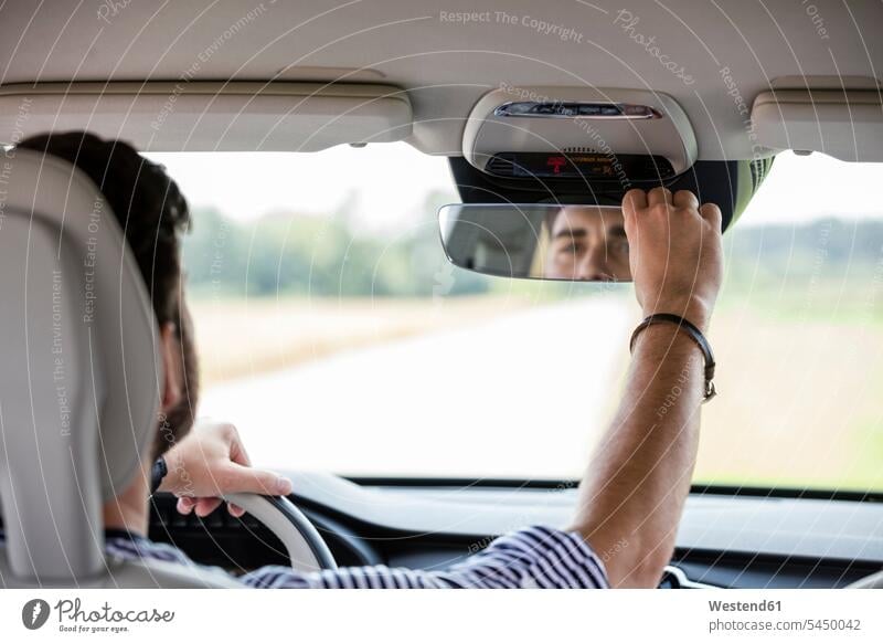 Mid adult man driving in car drive car driving motoring automobile Auto cars motorcars Automobiles Road Trip roadtrip Road-Trip motor vehicle road vehicle