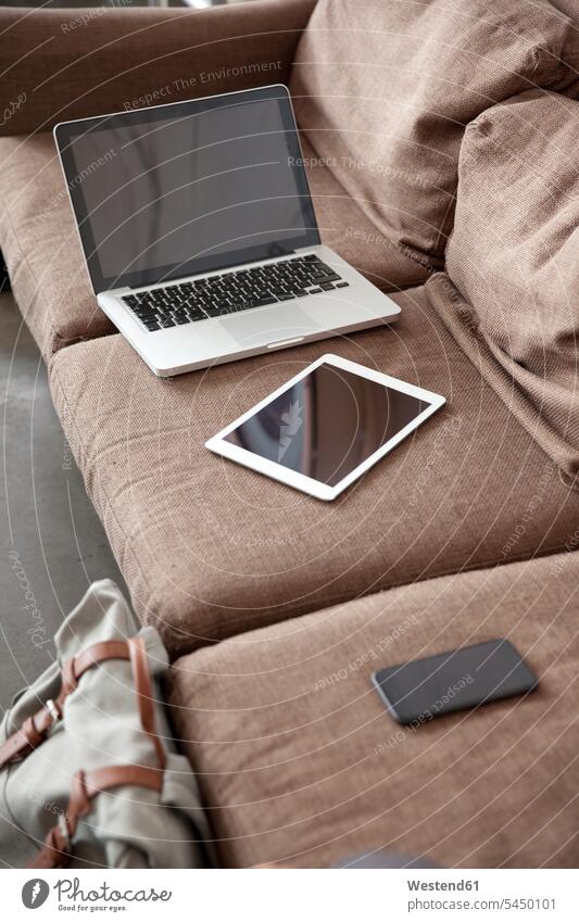 Laptop, tablet and smartphone on couch indoors indoor shot Interiors indoor shots interior view wireless Wireless Connection Wireless Technology