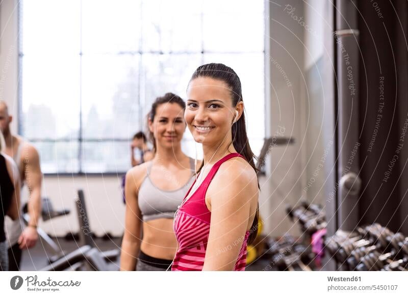 Young women in gym smiling confidently fit gyms Health Club young women young woman sportive sporting sporty athletic exercising exercise training practising