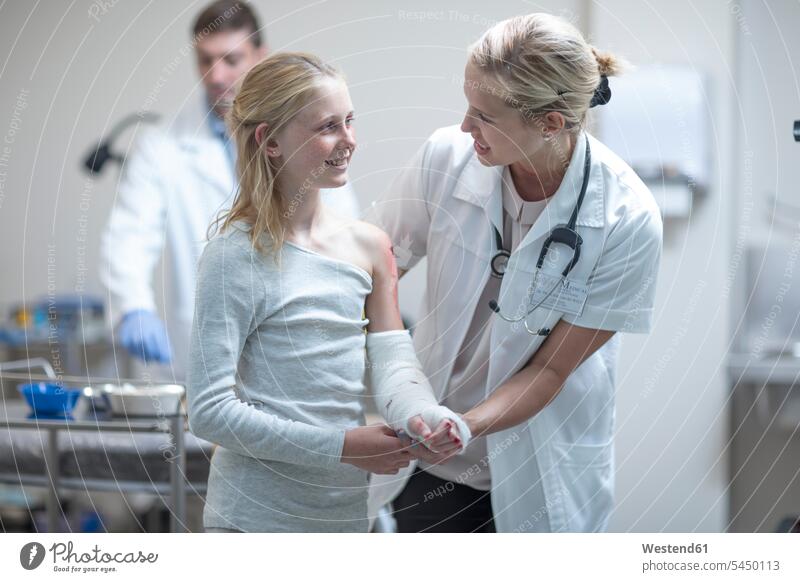 Doctor talking to injured girl in hospital doctor physicians doctors patient cast accident clinic hospitals Medical Clinic healthcare and medicine medical