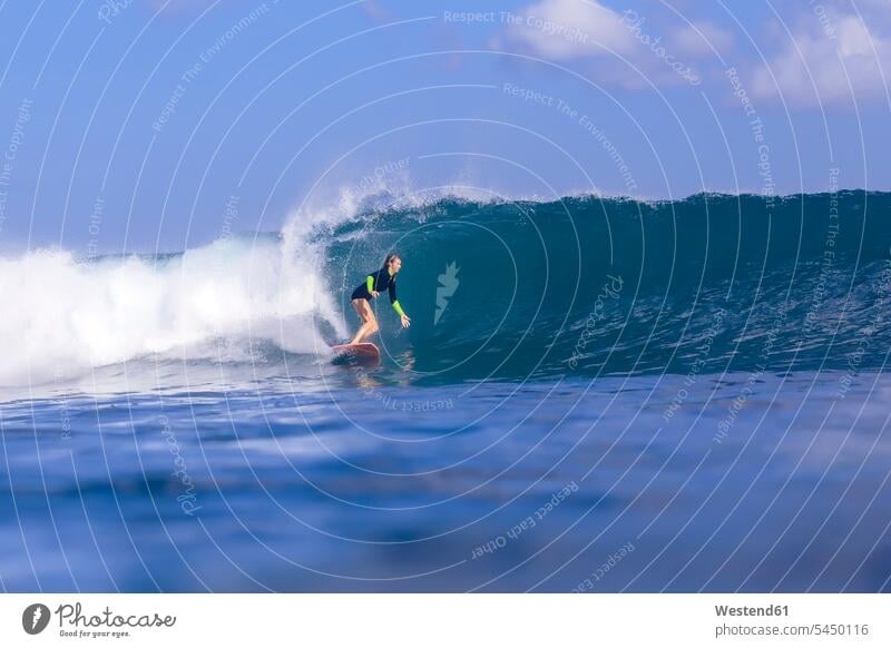Indonesia, Bali, woman surfing wave waves females women Sea ocean surf ride surf riding Surfboarding water Adults grown-ups grownups adult people persons