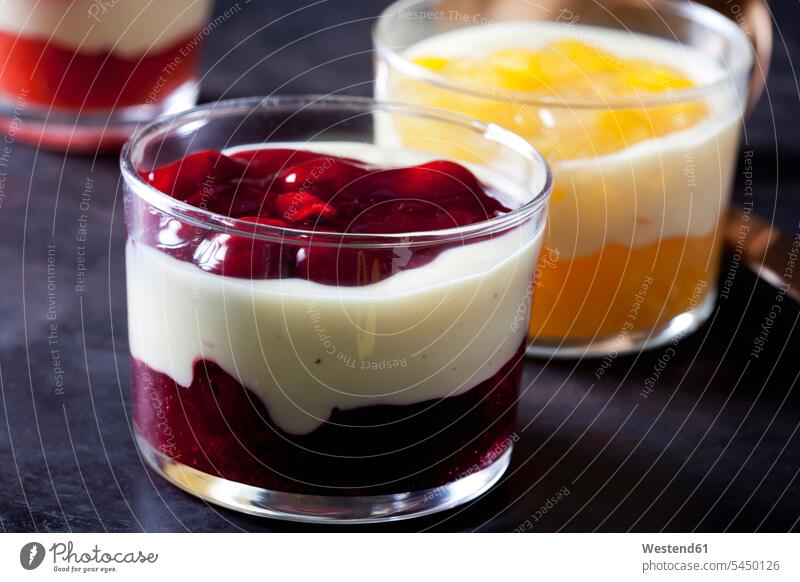 Red and yellow fruit compote with vanilla sauce layered in glasses nobody Orange Oranges Layers Berry berry fruits Berries Peach Peaches ready to eat