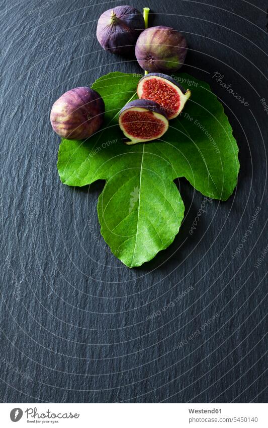 Sliced and whole figs and fig leaf on slate food and drink Nutrition Alimentation Food and Drinks schist slates sweet Sugary sweets healthy eating nutrition