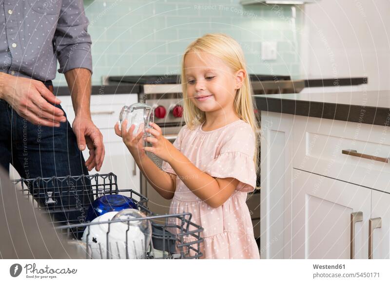 Girl helping father clearing the dishwasher in kitchen daughter daughters domestic kitchen kitchens assistance assisting Help pa fathers daddy dads papa girl