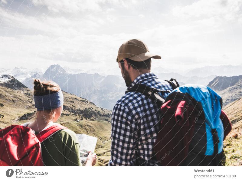 Germany, Bavaria, Oberstdorf, two hikers with map in alpine scenery couple twosomes partnership couples hiking maps mountain range mountains mountain ranges