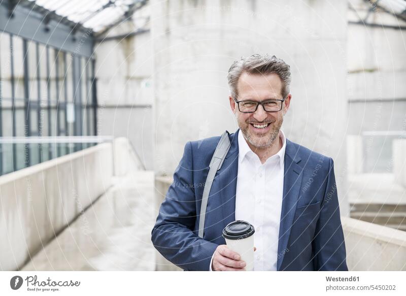 Portrait of content businessman with coffee to go Businessman Business man Businessmen Business men portrait portraits business people businesspeople