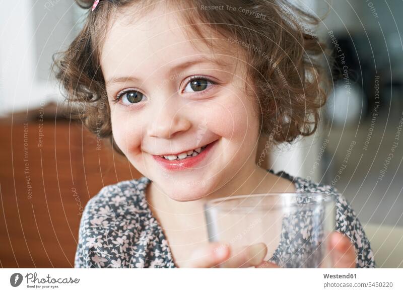 Portrait of smiling little girl with glass females girls portrait portraits child children kid kids people persons human being humans human beings Glass