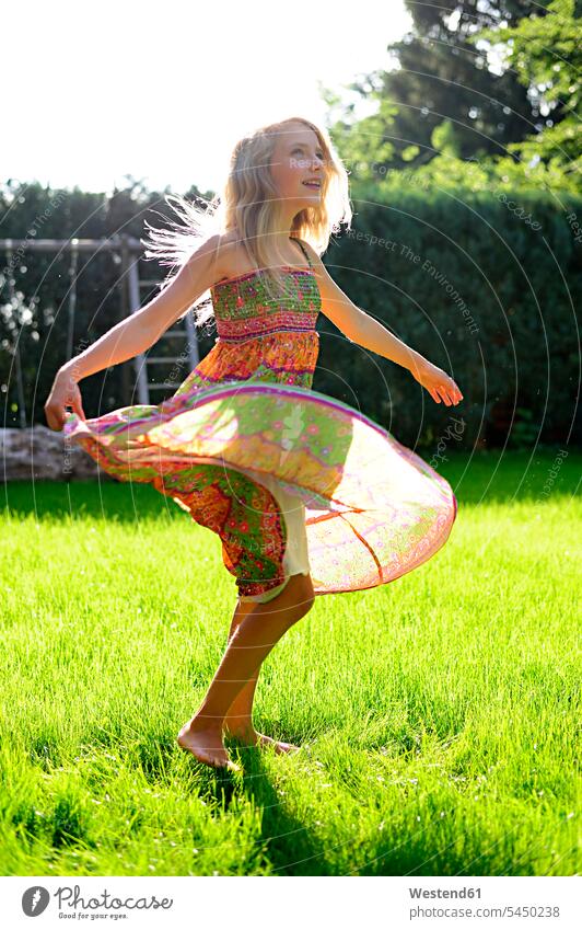 Happy girl wearing a dress in garden females girls dresses smiling smile gardens domestic garden child children kid kids people persons human being humans