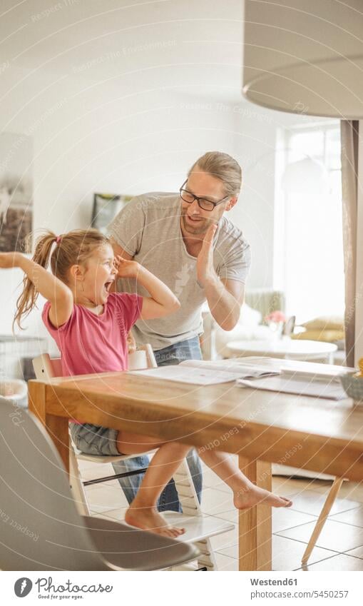 Father high fiving with daughter daughters father pa fathers daddy dads papa Joy enjoyment pleasure Pleasant delight homework Home work child children family
