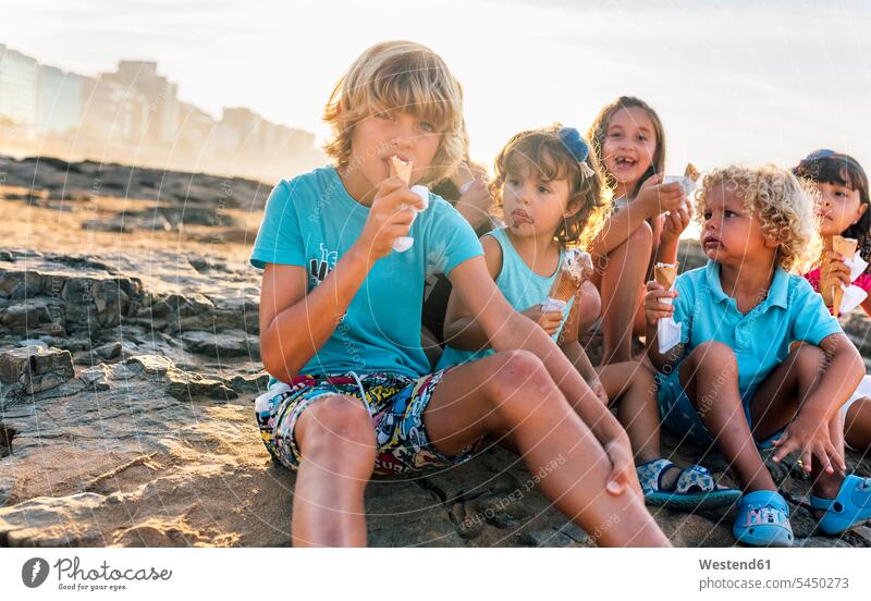 Group of six children eating icecream on the beach kid kids Sweet Food sweet foods food and drink Nutrition Alimentation Food and Drinks people persons