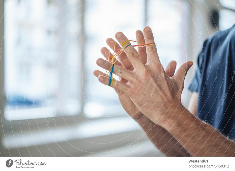 Close-up of man holding rubber bands hand human hand hands human hands Businessman Business man Businessmen Business men people persons human being humans