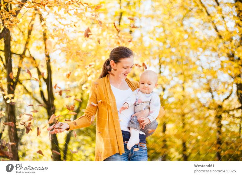Mother and baby girl having fun with leaves in autumn Leaf Leaves Fun funny mother mommy mothers ma mummy mama infants nurselings babies fall baby girls female