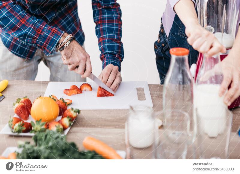 Couple preparing smoothies with fresh fruits and vegetables, partial view couple twosomes partnership couples Food Preparation preparing food Smoothies people