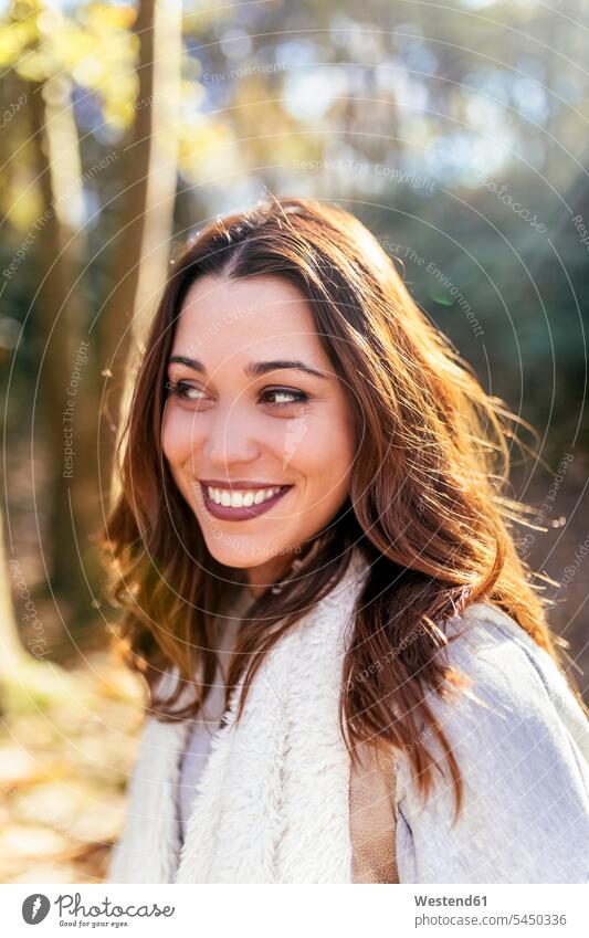 Portrait of a beautiful smiling woman in an autumnal forest portrait portraits females women fall woods forests smile Adults grown-ups grownups adult people