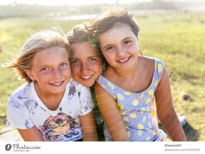 Group picture of three girls head to head in summer female friends females portrait portraits mate friendship child children kid kids people persons human being