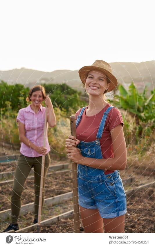 Portrait of happy young farmer portrait portraits woman females women smiling smile gardening yardwork yard work Adults grown-ups grownups adult people persons