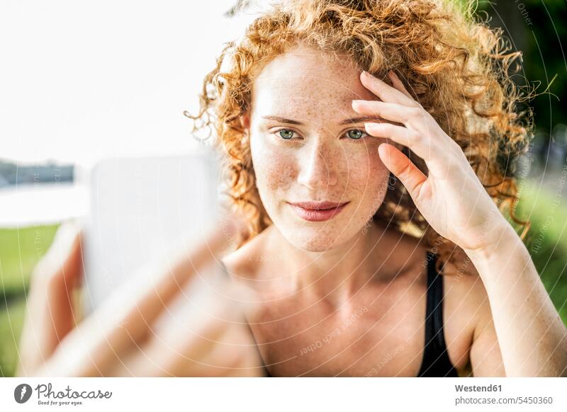 Portrait of freckled young woman taking selfie with cell phone portrait portraits freckles females women Selfie Selfies Adults grown-ups grownups adult people
