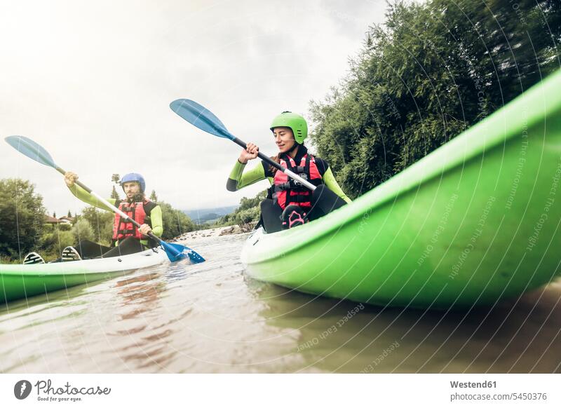 Germany, Bavaria, Allgaeu, couple kayaking on river Iller River Rivers paddling paddle canoe twosomes partnership couples water waters body of water