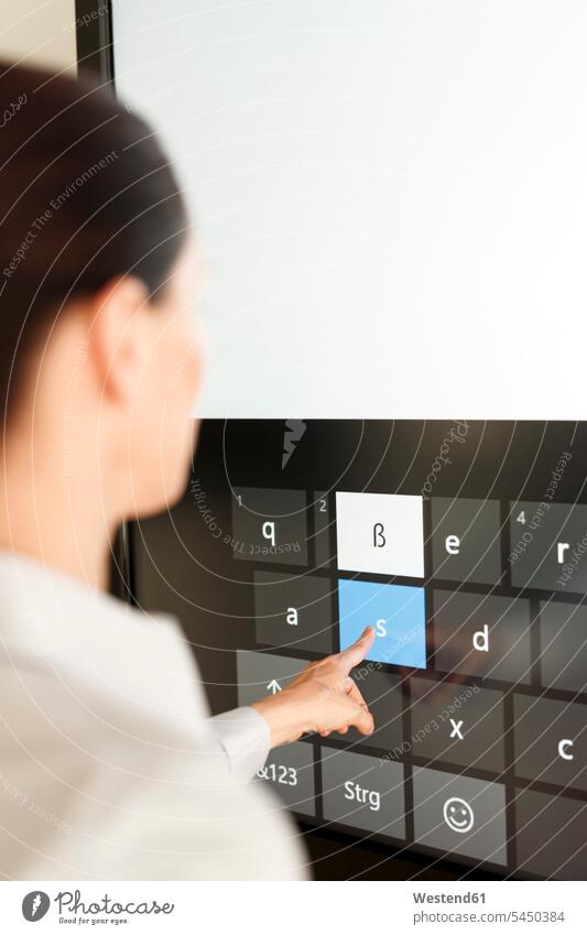 Businesswoman using projection of a keyboard screen screens monitor monitors workshop training training course Projection businesswoman businesswomen