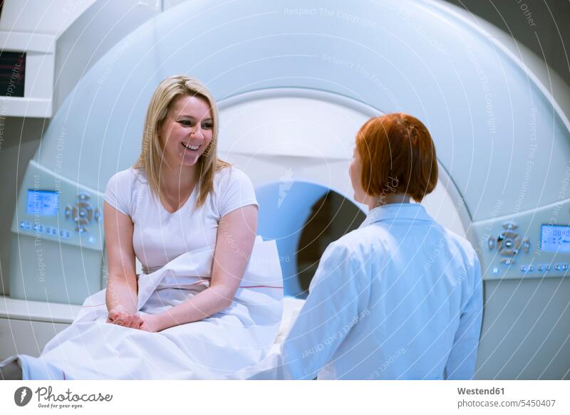 Doctor discussing MRT result with patient magnetic resonance tomography Female Doctor physicians Female Doctors examination examine examinations examining