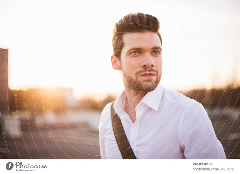 Portrait of young businessman at sunset Businessman Business man Businessmen Business men portrait portraits males business people businesspeople business world