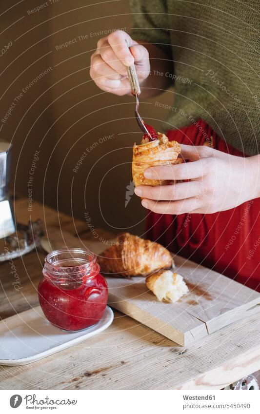 Close-up of woman tasting homemade croissants with jam females women Jam Jelly Marmalade eating Croissant Croissants Cornetto Cornettos Adults grown-ups