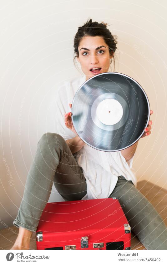 Portrait of woman with record and record player vinyl record records females women portrait portraits analogue Media Adults grown-ups grownups adult people