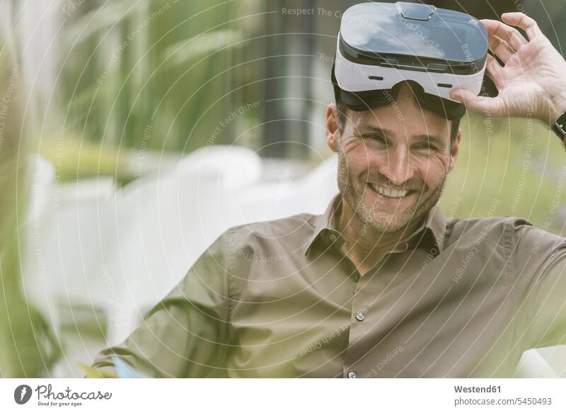 Portrait of smiling man with Virtual Reality Glasses portrait portraits Businessman Business man Businessmen Business men smile freelancer freelancing