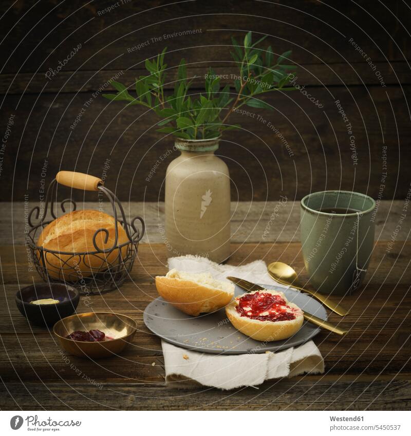 Bread roll with jam and cup of tea food and drink Nutrition Alimentation Food and Drinks wire basket rustic Tea Teas wooden Butter Plate dish dishes Plates