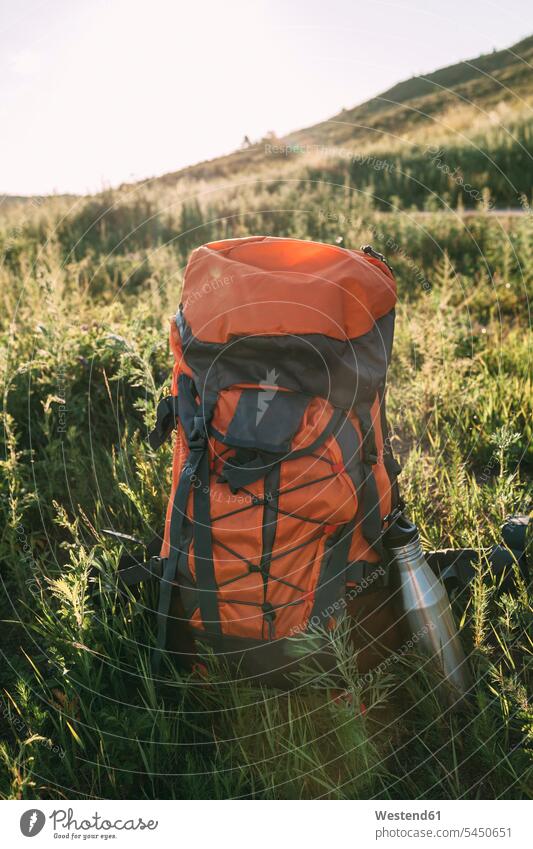 Backpack and thermos flask on a meadow nature natural world meadows rural scene Non Urban Scene Freedom Liberty free tranquility tranquillity Calmness Challenge
