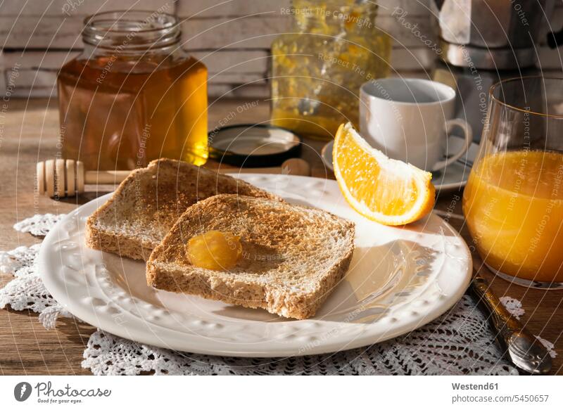 Breakfast table with toast, orange marmalade, honey, orange juice and espresso Glass Glasses tasty savoury yummy Mouth-watering appetising savory Mouthwatering