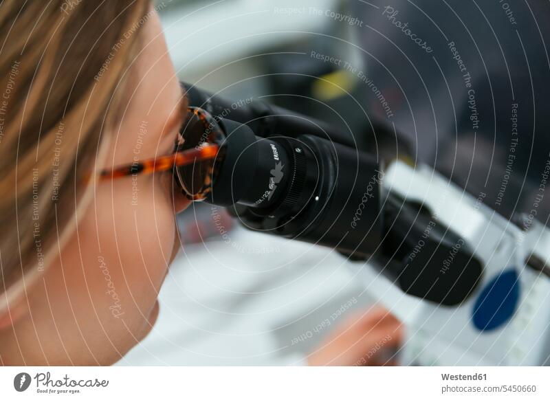 Close-up of woman using microscope laboratory microscopes laboratory technician females women examining checking examine working At Work workplace work place