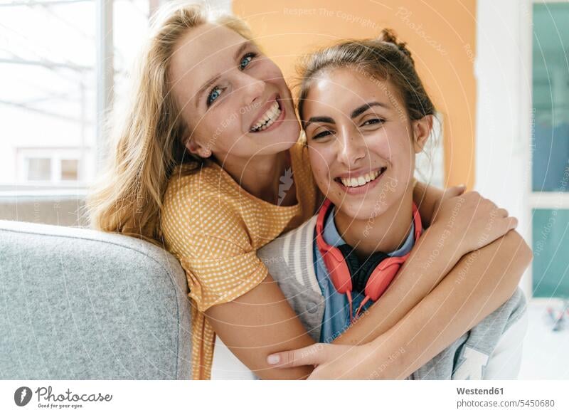 Portrait of two happy young women hugging female friends woman females happiness portrait portraits embracing embrace Embracement mate friendship Adults