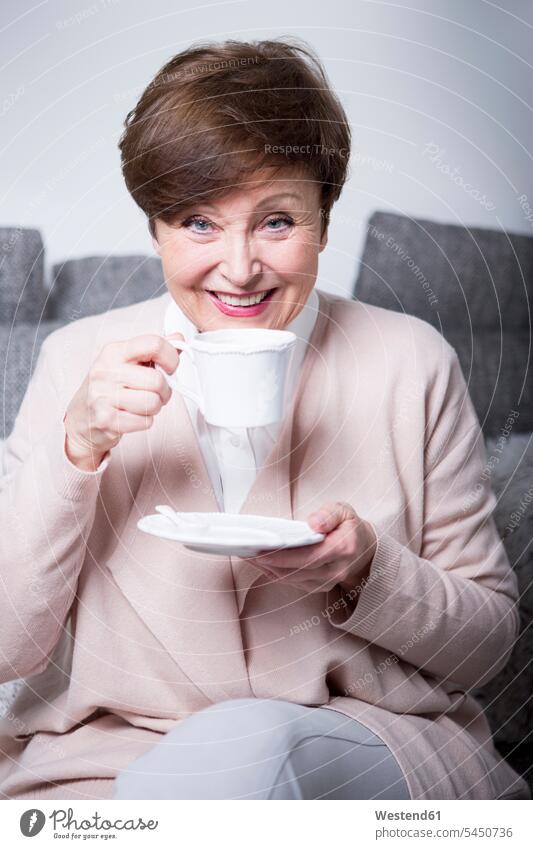 Portrait of a senior woman drinking coffee Coffee females women senior women elder women elder woman old sitting Seated Drink beverages Drinks Beverage