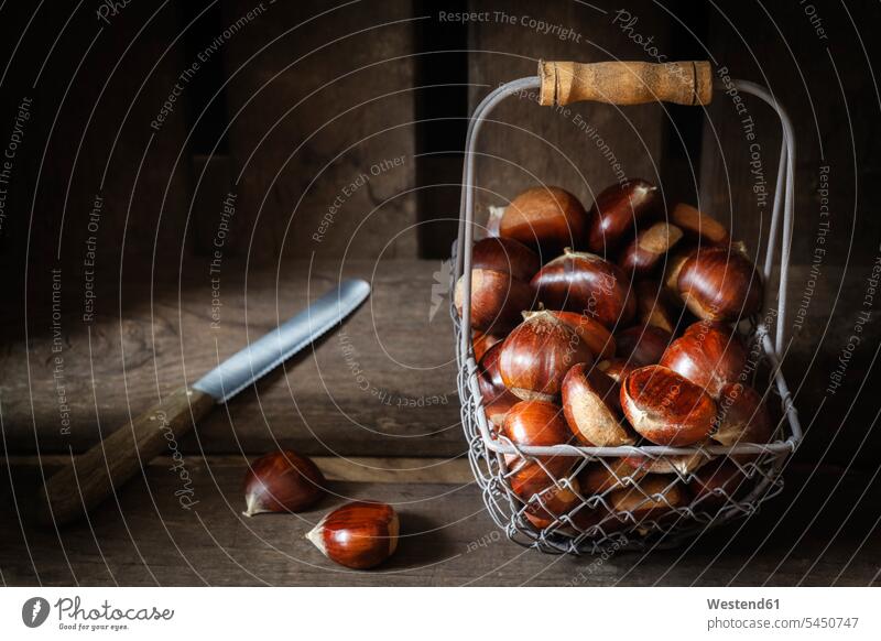 Sweet chestnuts in wire basket food and drink Nutrition Alimentation Food and Drinks Chestnut Chestnuts Aesculus hippocastanum Light collecting collected