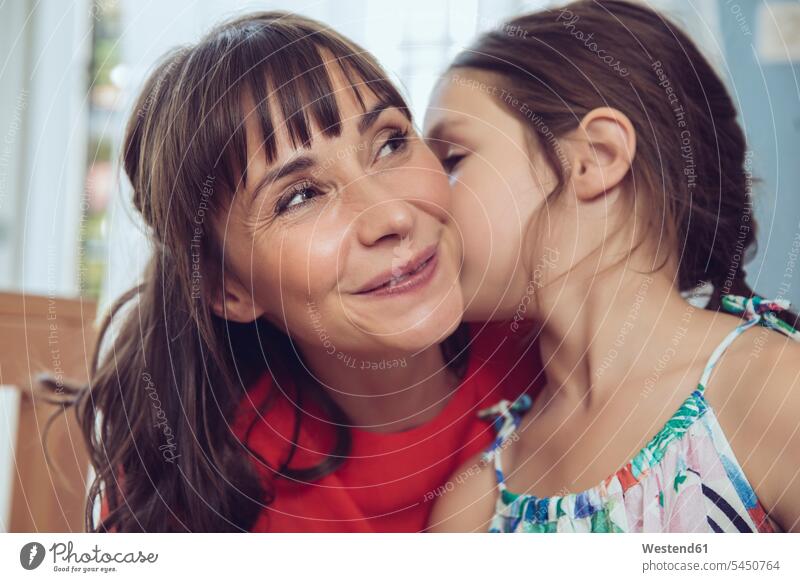 Daughter telling mother a secret daughter daughters kissing kisses mommy mothers ma mummy mama family families smiling smile child children people persons