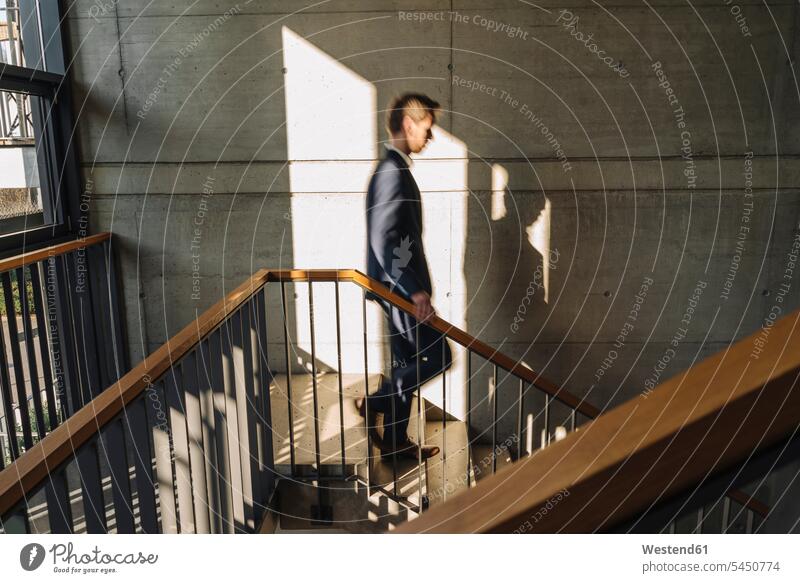Businessman walking down stairs going stairway Business man Businessmen Business men business people businesspeople business world business life staircase