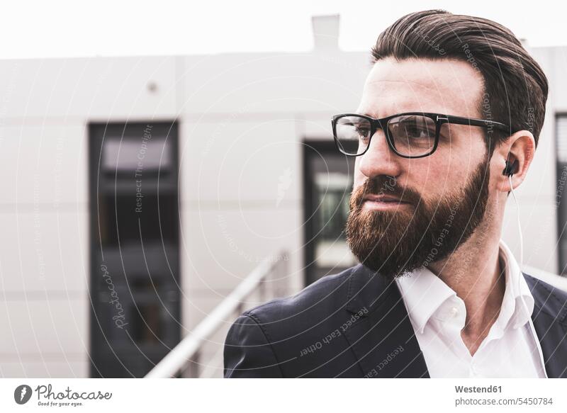 Portrait of a bearded, young businessman , wearing spectacles Businessman Business man Businessmen Business men people persons human being humans human beings